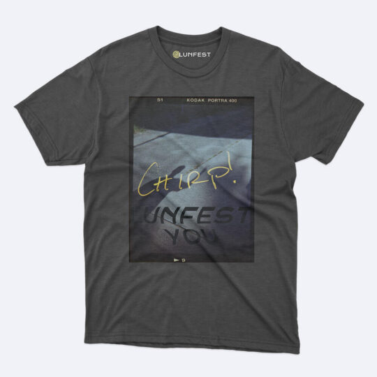 A t-shirt with an image of a car parked on the side of a road.